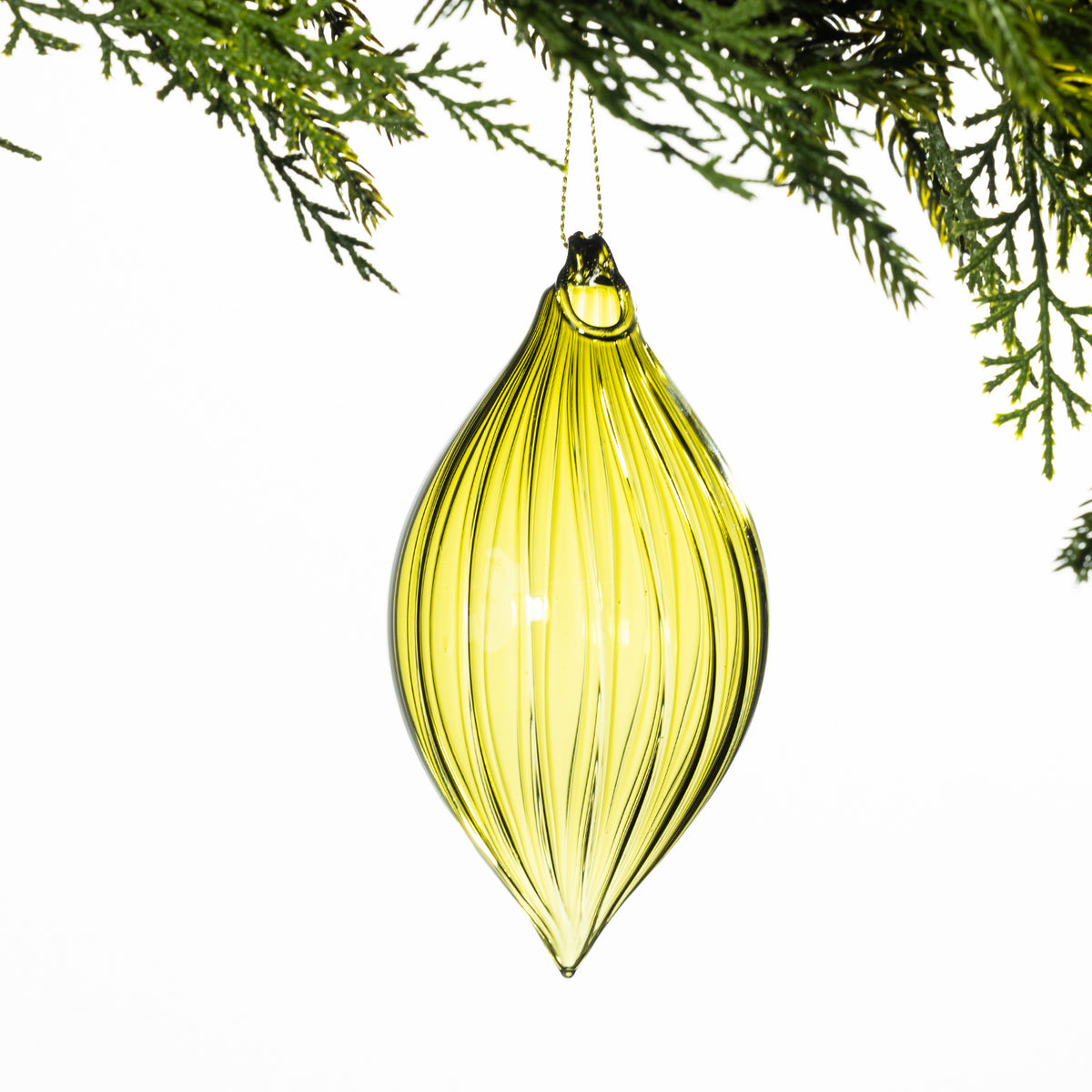 Green elongated glass Christmas bauble featuring elegant vertical ribbed detailing and a pointed teardrop shape, hanging from festive greenery.