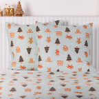 Christmas Wishes Sugar Spruce Euro Pillowcase Pair featuring gingerbread men, Christmas trees and gingerbread houses on a pale mint background, styled with matching bedding.