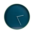 A minimalist round wall clock with a dark teal-blue face, a thin green outer rim, and light blue hands, shown against a plain white background.