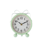 Mint green round table clock with a white face, black numerals and hands, decorative ribbon-style loops and two rounded feet, shown front-on against a white background.