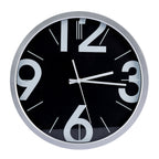 A round wall clock with a black face, large white Arabic numerals, and silver-tone hands and outer rim, shown against a plain white background.