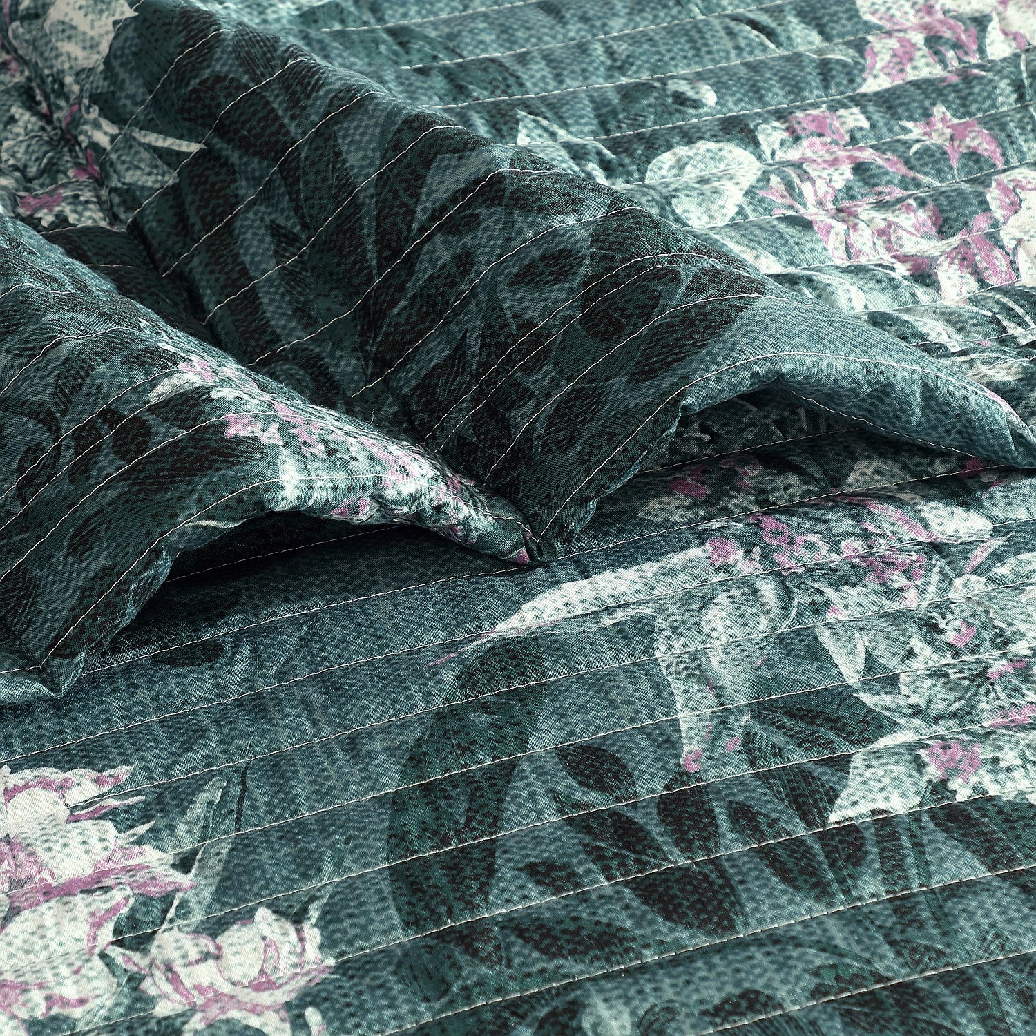 Green floral comforter set styled on a bedup close 
