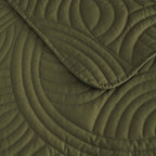 Olive green quilted coverlet close-up showing textured stitched pattern 