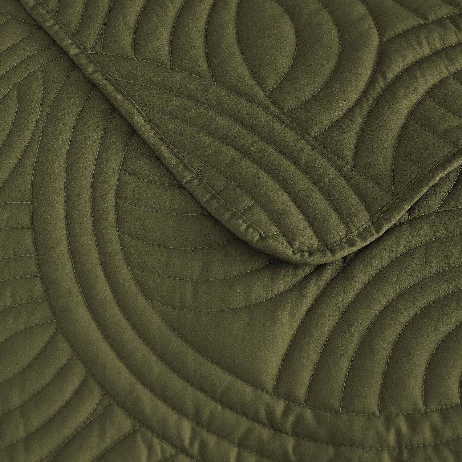 Olive green quilted coverlet close-up showing textured stitched pattern 