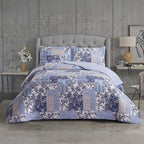 Blue and white patterned duvet cover set styled on a bed with matching pillowcases in a modern bedroom.