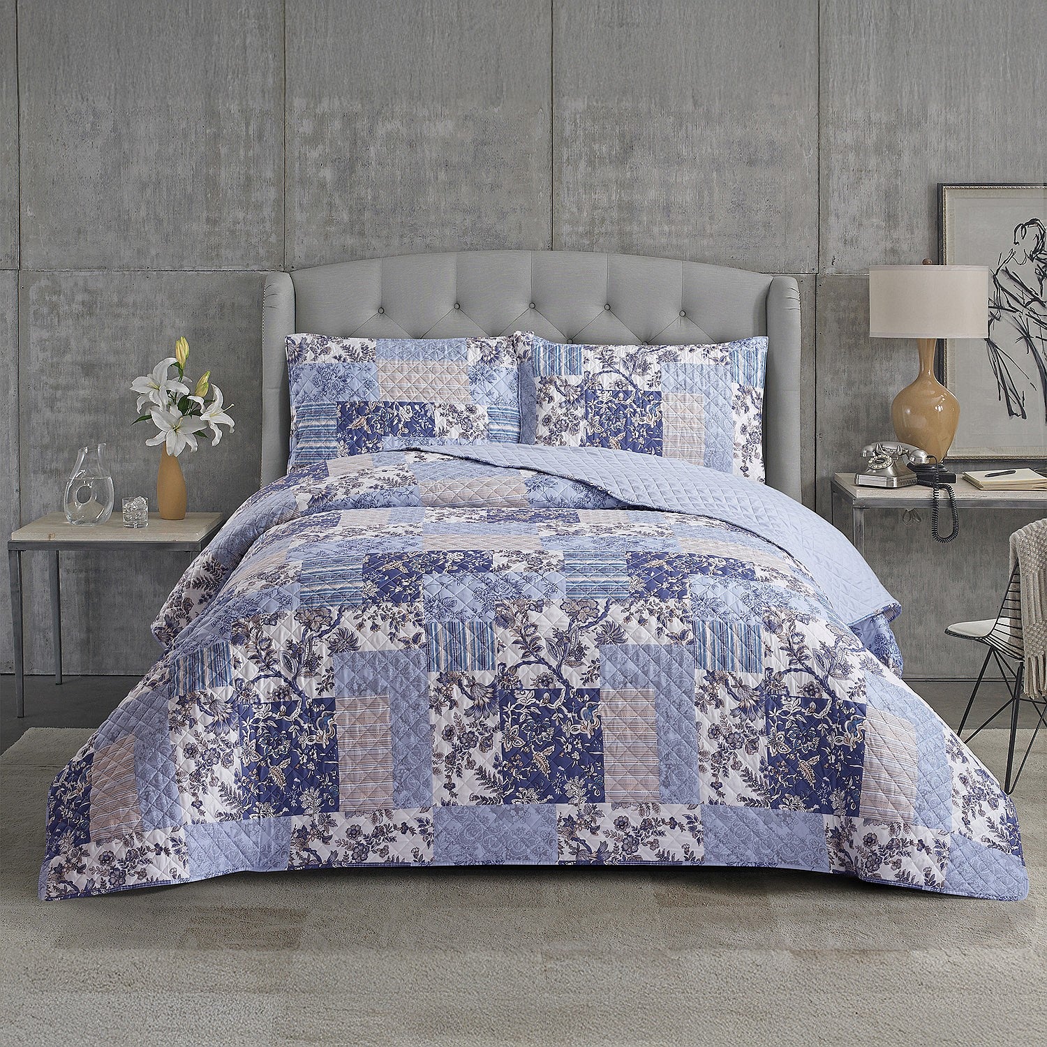 Blue and white patterned duvet cover set styled on a bed with matching pillowcases in a modern bedroom.