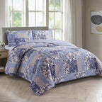 Blue and white patterned duvet cover set styled on a bed with matching pillowcases in a modern bedroom.