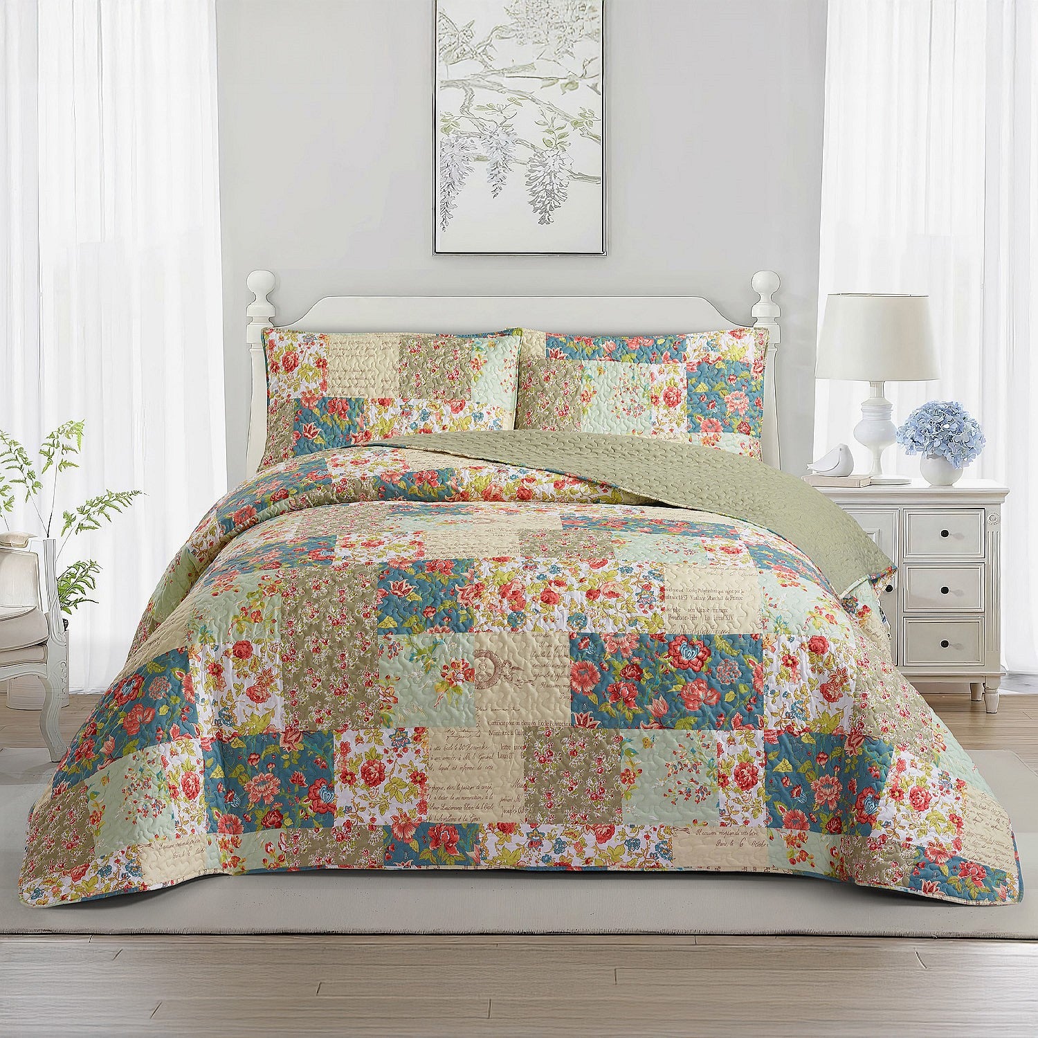 Multicoloured patchwork coverlet set styled on a bed with matching pillowcases in a bright bedroom.