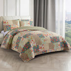 Multicoloured patchwork coverlet set styled on a bed with matching pillowcases in a bright bedroom.