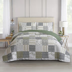 Green, grey and cream patchwork coverlet set styled on a bed with matching pillowcases in a bright bedroom.