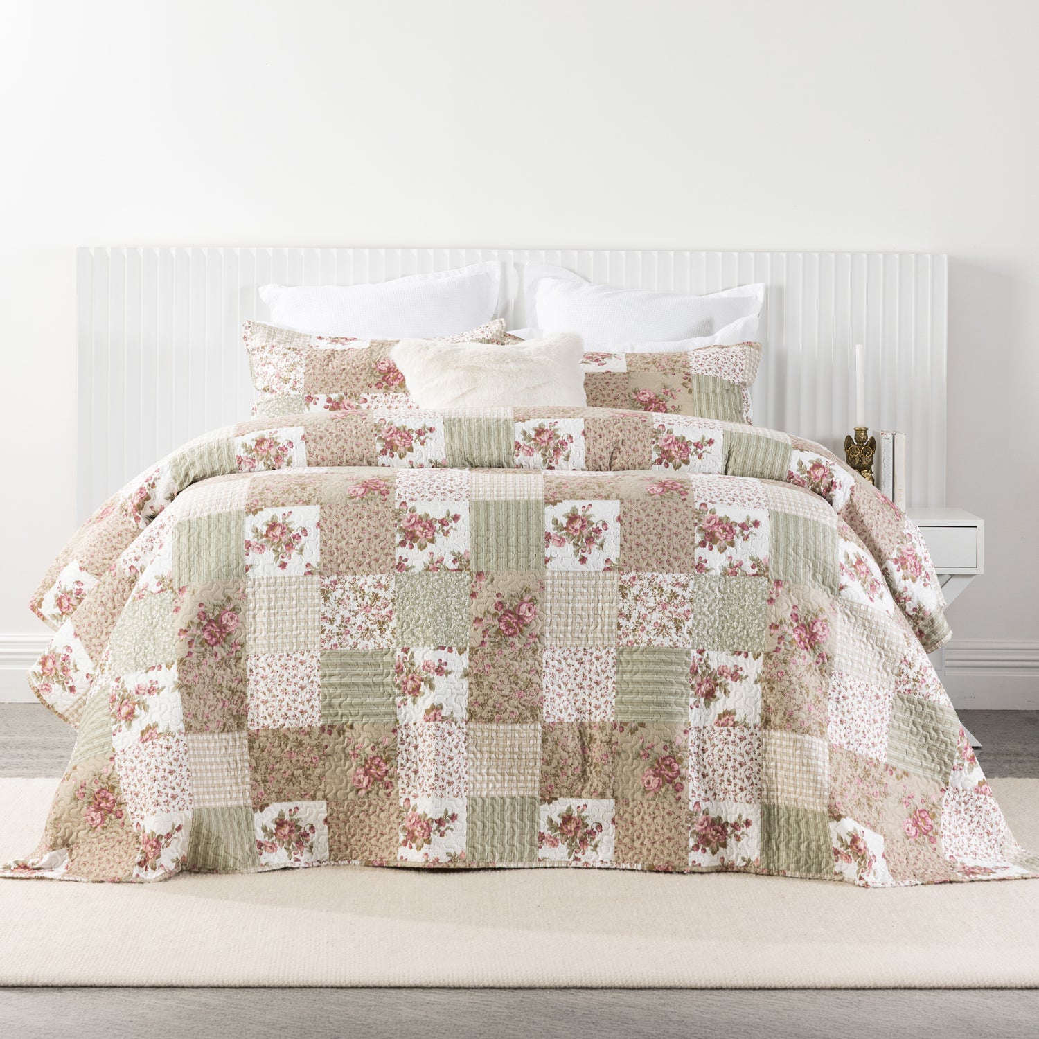 A charming patchwork floral coverlet set in soft blush, sage and cream tones brings a warm country-inspired feel to the bedroom with its delicate vintage-inspired prints.