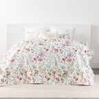 A delicate wildflower coverlet set in soft pink, lilac, blue and green tones brings a fresh garden-inspired charm to the bedroom with its light, airy floral design.