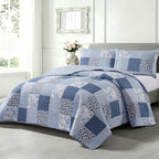 Home Co. Jax Patchwork Coverlet Set in Blue, styled on a bed with coordinating patchwork pillow shams in a bright contemporary bedroom.