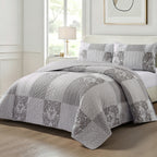 Home Co. Tara Patchwork Coverlet Set in Grey Beige, styled on a bed with coordinating patchwork pillow shams in a bright neutral bedroom.