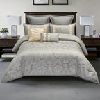 Grey patterned comforter set styled on a bed with matching pillows in a modern bedroom.