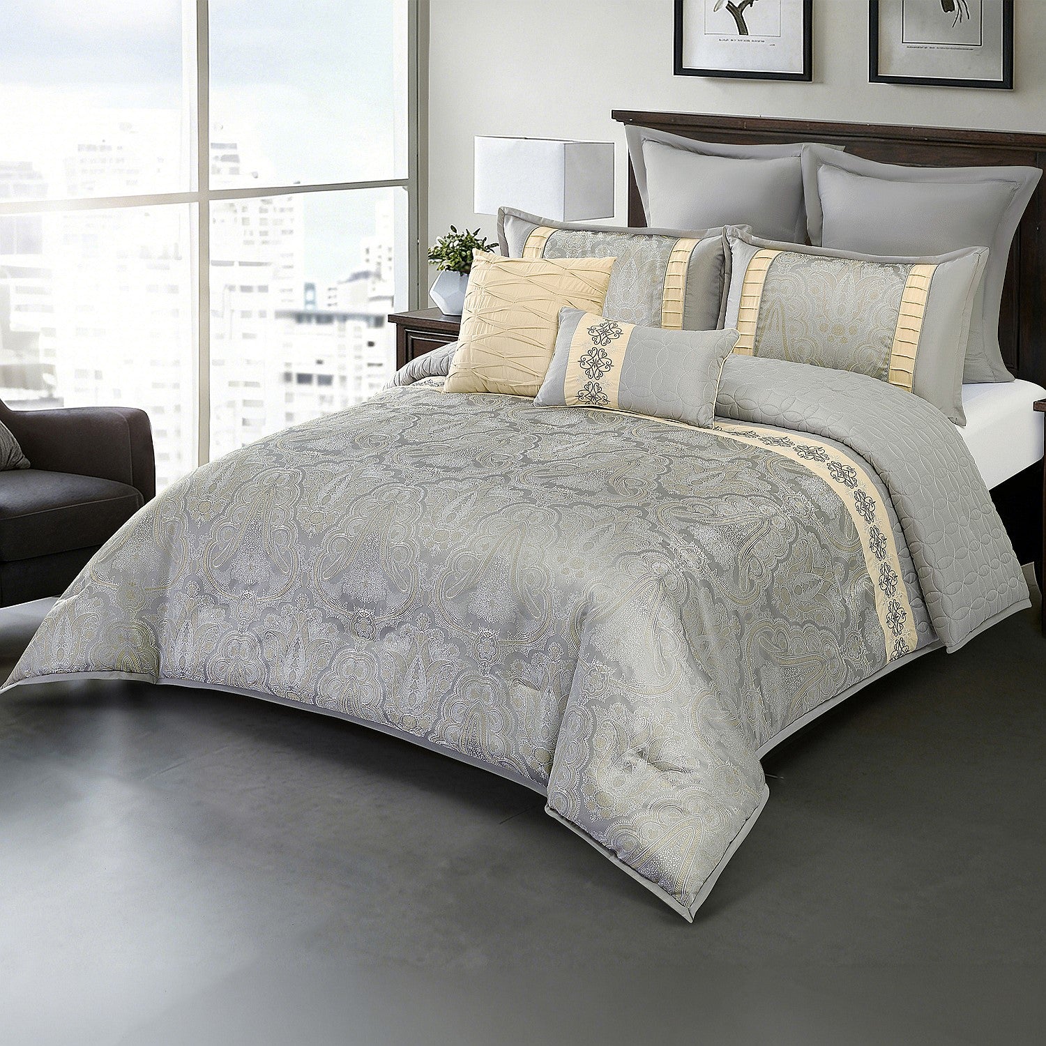 Grey patterned comforter set styled on a bed with matching pillows in a modern bedroom.
