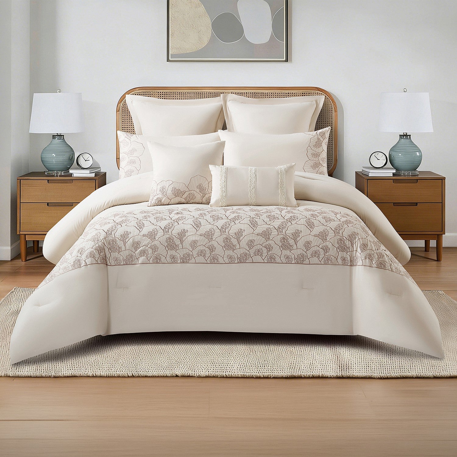 Neutral comforter set styled on a bed with matching pillows and a decorative throw in a bright bedroom.