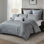 Grey ribbed comforter set styled on a bed with matching pillows in a neutral bedroom.