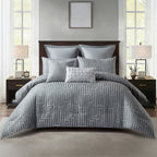 Grey ribbed comforter set styled on a bed with matching pillows in a neutral bedroom.