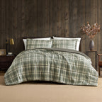Green and cream check duvet cover set styled on a bed with matching pillowcases in a dark wood bedroom.
