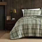 Green and cream check duvet cover set styled on a bed with matching pillowcases in a dark wood bedroom.
