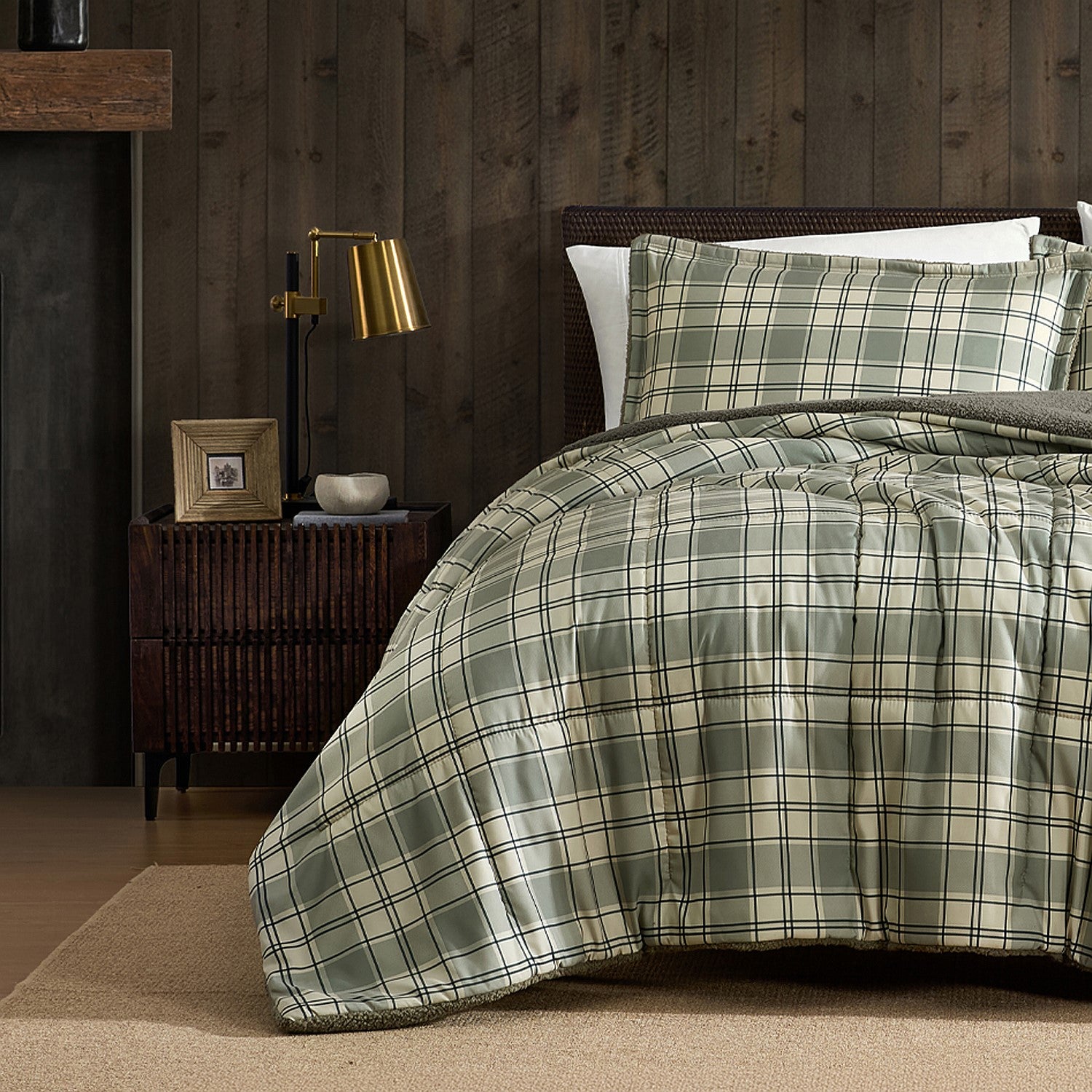 Green and cream check duvet cover set styled on a bed with matching pillowcases in a dark wood bedroom.
