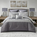 Grey quilted comforter set styled on a bed with matching pillows in a modern bedroom.