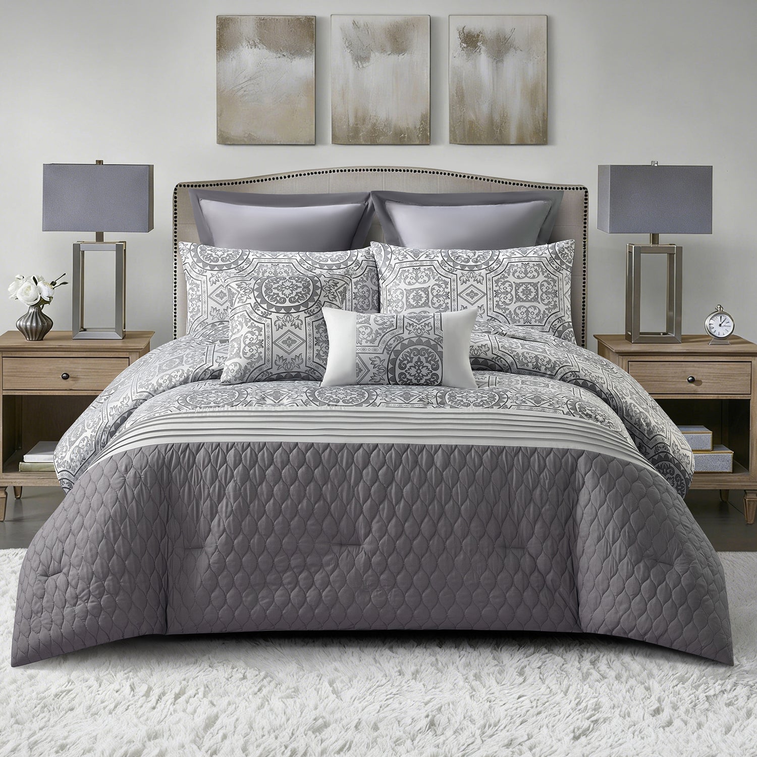 Grey quilted comforter set styled on a bed with matching pillows in a modern bedroom.