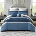 Blue striped comforter set styled on a bed with matching pillows in a bright modern bedroom.