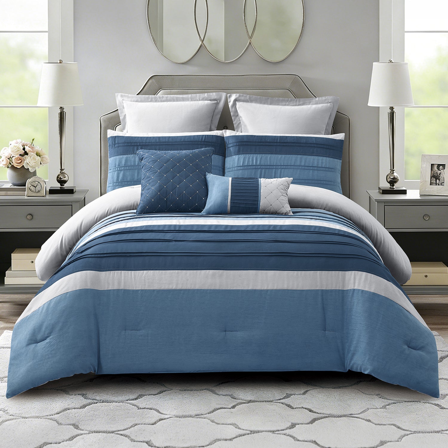 Blue striped comforter set styled on a bed with matching pillows in a bright modern bedroom.