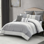 A gray and white patterned comforter set styled on a bed in a modern bedroom setting, featuring a Geometric pattern and matching pillows.