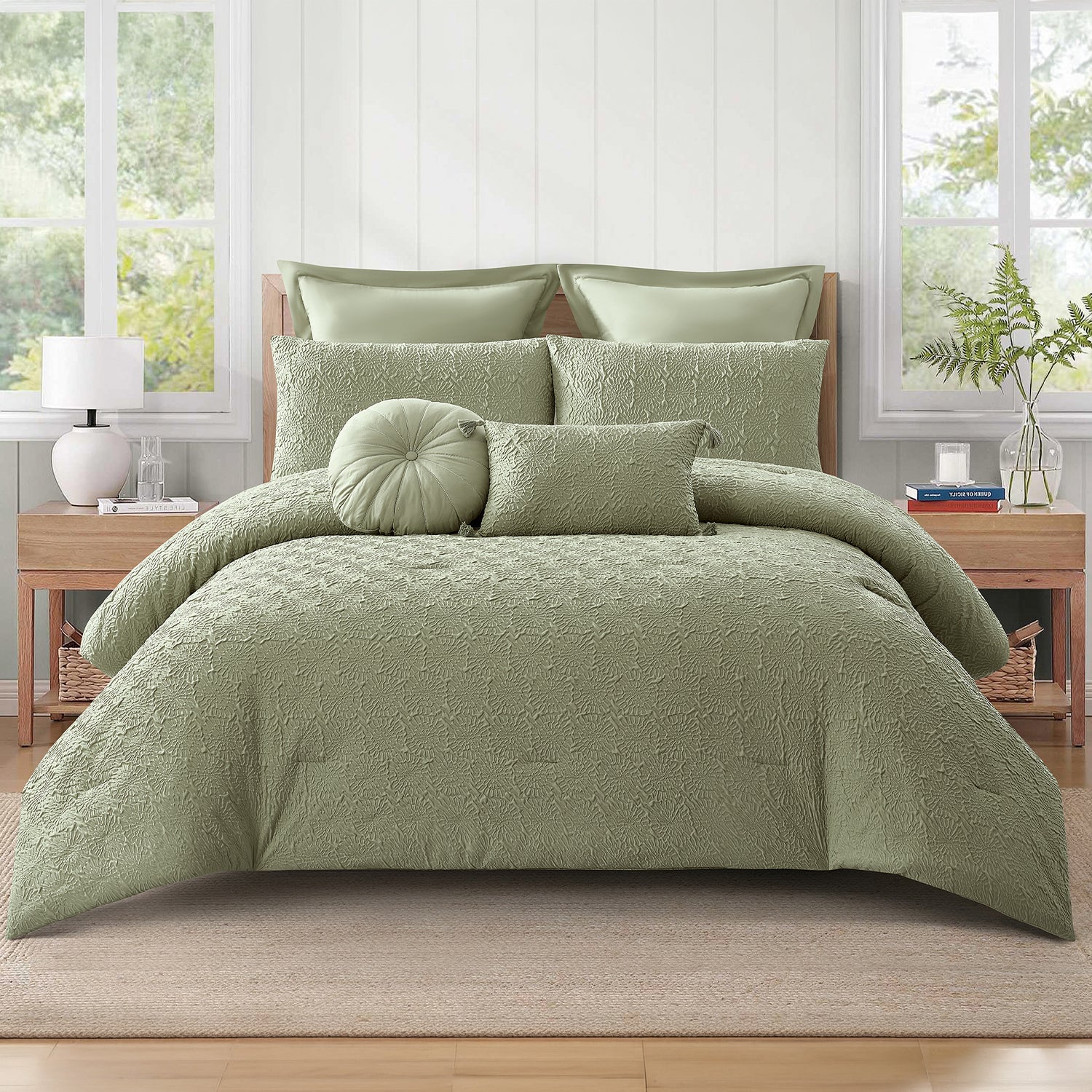 Sage green textured 7-piece comforter set styled on a bed with matching pillows, a round cushion, and a rectangular cushion in a bright bedroom.