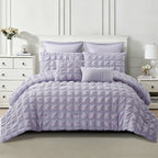 Lilac seersucker comforter set styled on a bed with coordinating pillowcases and decorative cushions, showing the textured grid design.