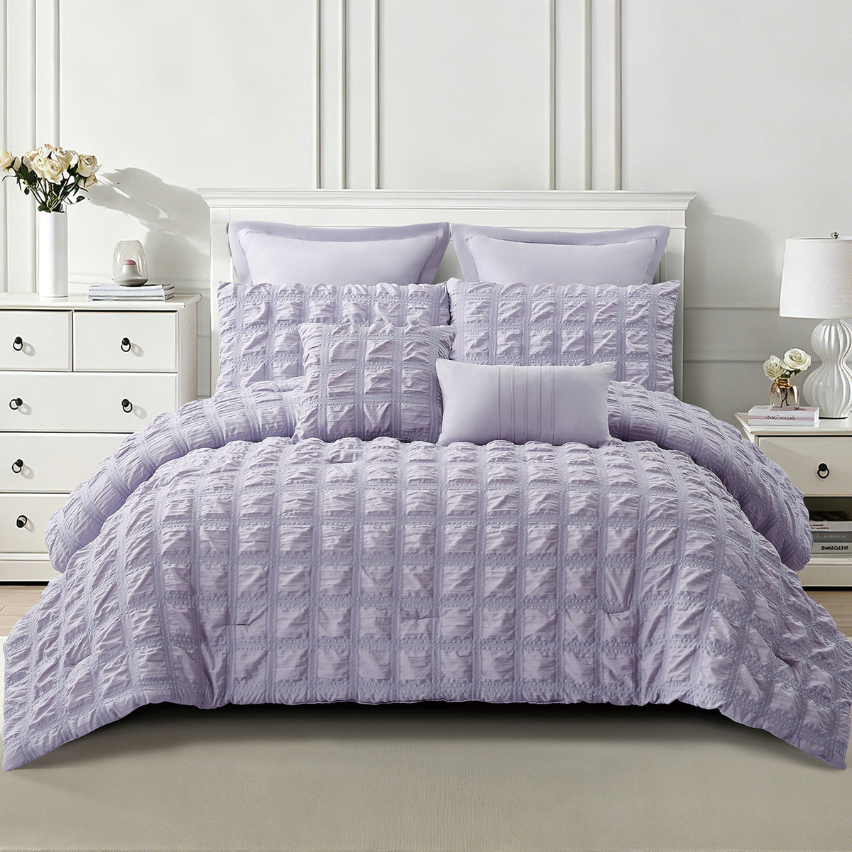Lilac seersucker comforter set styled on a bed with coordinating pillowcases and decorative cushions, showing the textured grid design.