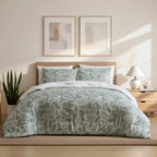 Home Co. Toa Comforter Set featuring a soft seafoam green and white leafy print, styled on a bed in a bright contemporary bedroom.