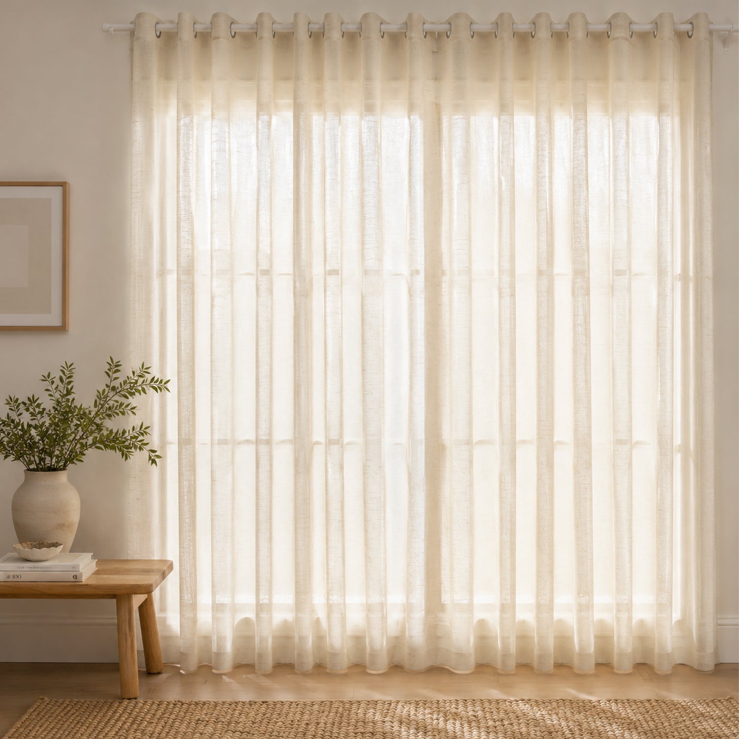 Soft linen sheer eyelet curtains gently filter natural light, creating a bright, airy, and inviting living space.