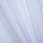 A close-up of a white sheer curtain highlights its finely woven texture and soft, flowing drape as it gently filters natural light.