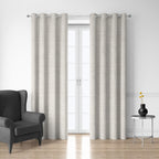 Style Co. Belmont Blockout Eyelet Curtain Pair in natural displayed over glass doors in a modern living room with silver eyelets.