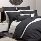 Black and white bedding set on a bed in a bedroom setting.