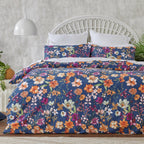 Floral bedding set on a bed with a white headboard and gray wall.