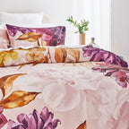 Floral patterned bedding set on a bed with a plant in the background