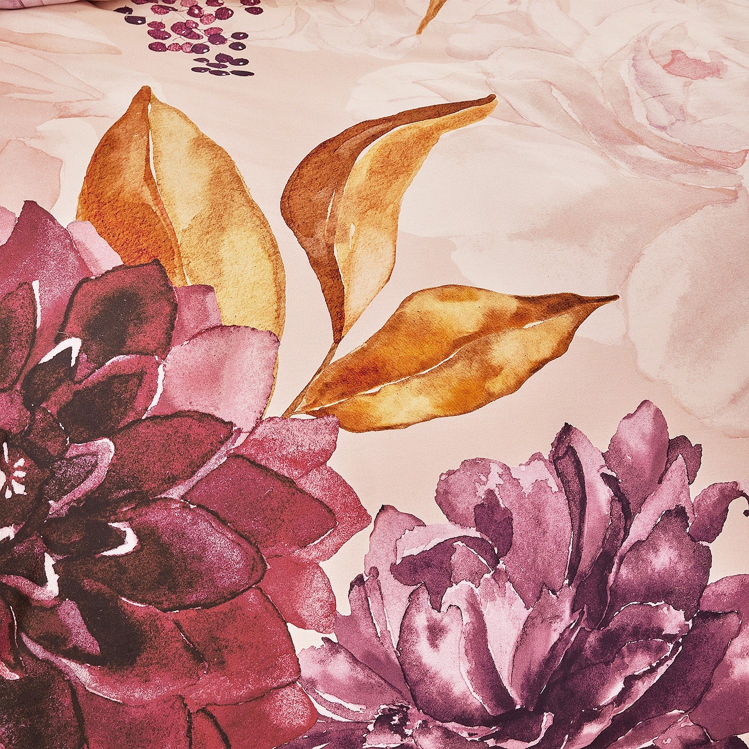 Close-up of floral and leaf design on fabric with pink and purple flowers.