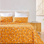 Yellow floral bedspread set on a bed in a bedroom setting