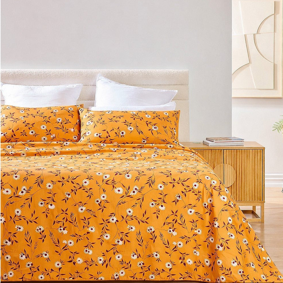 Yellow floral bedspread set on a bed in a bedroom setting