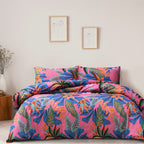 Colorful floral bedding set on a bed in a room with framed pictures on the wall.