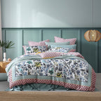 Floral bedding set on a bed with a green headboard and decorative elements.