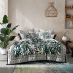 Bed with tropical leaf patterned bedding in a bedroom setting.