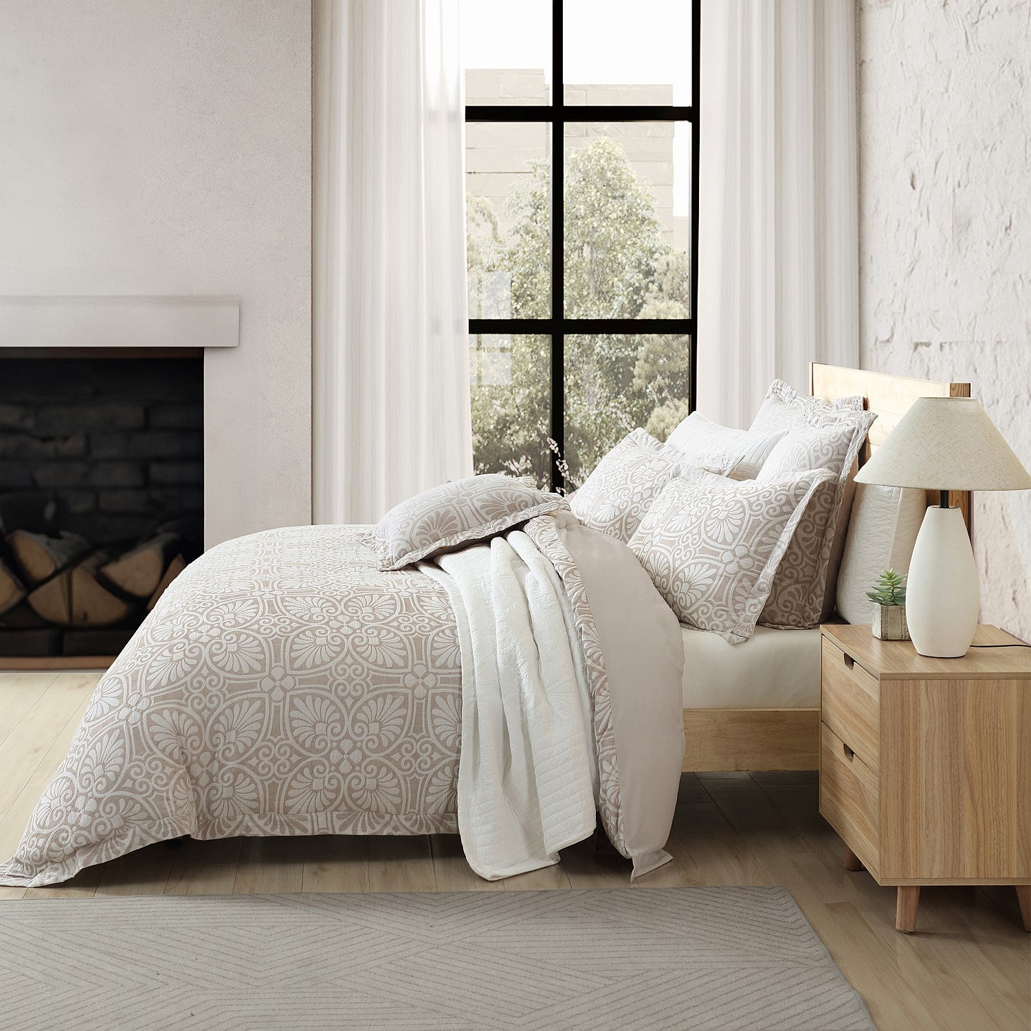 Neatly made bed with patterned bedding in a bedroom setting.