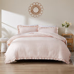 Pink textured comforter set on a bed in a bedroom with decorative elements.