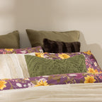Floral-patterned pillows on a bed with a neutral background
